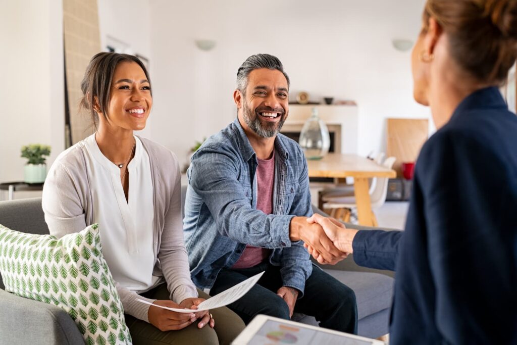 couple handshake with consultant at home