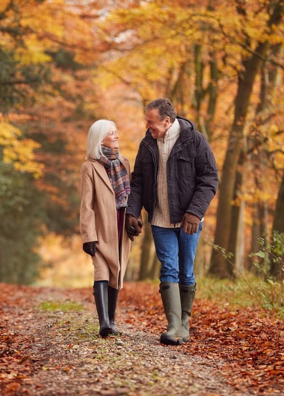 Couple strolling in the woods on a lovely autumnal day