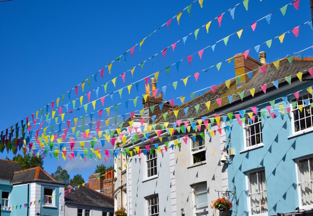 Row of coloured houses with a burst of colourful bunting