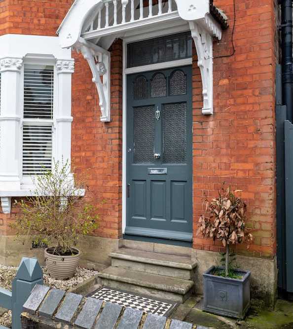 A typical red brick suburban house front door and bay window in South London