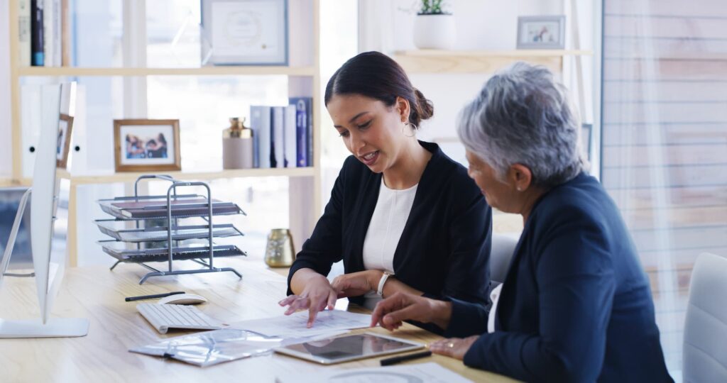 Old woman, lawyer and reading document in office for planning, debt settlement and legal guidance. Senior person, attorney and paperwork for retirement fund, asset protection and pension